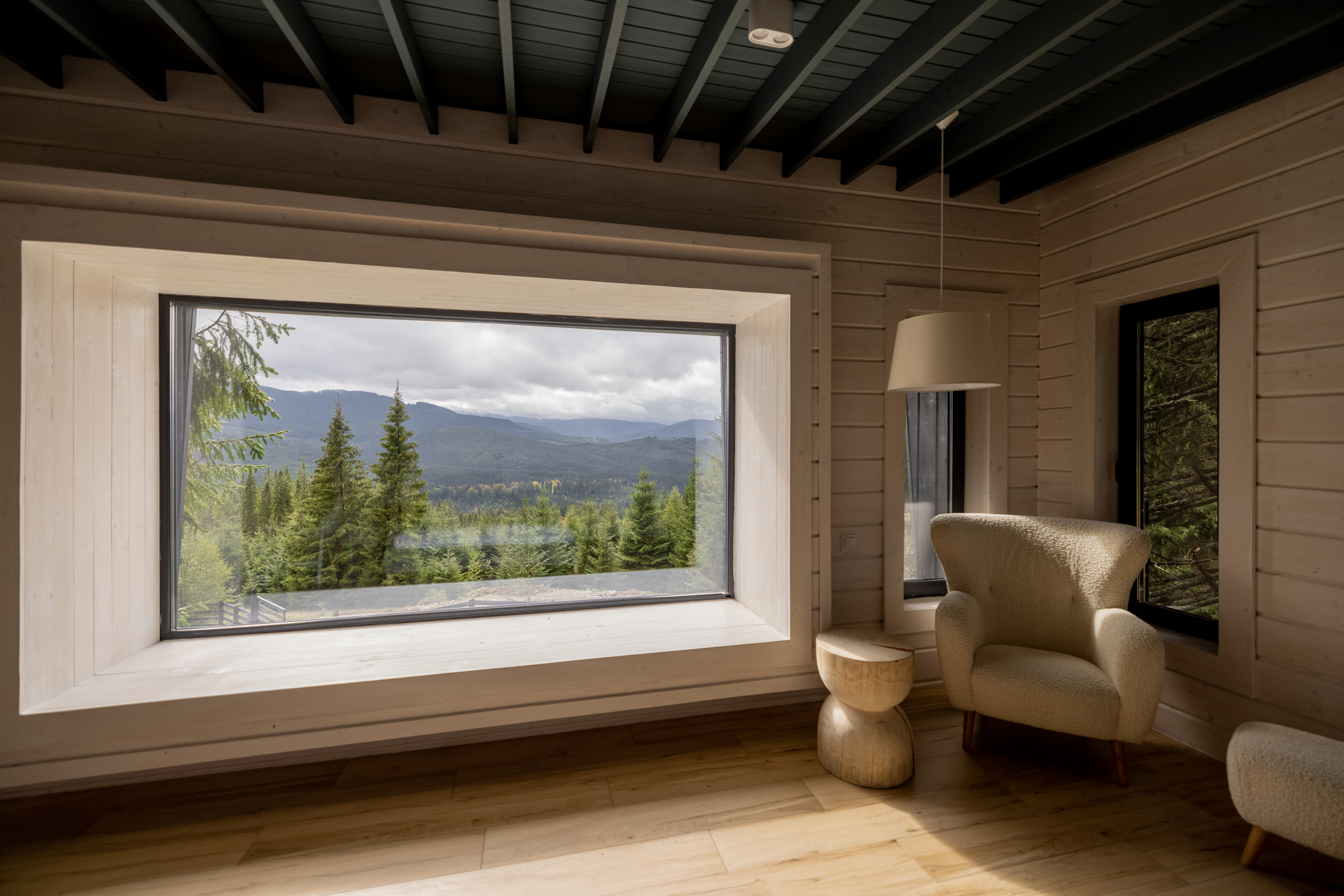 wooden-house-interior-with-panoramic-window-and-sc-2026-01-08-07-48-44-utc 1